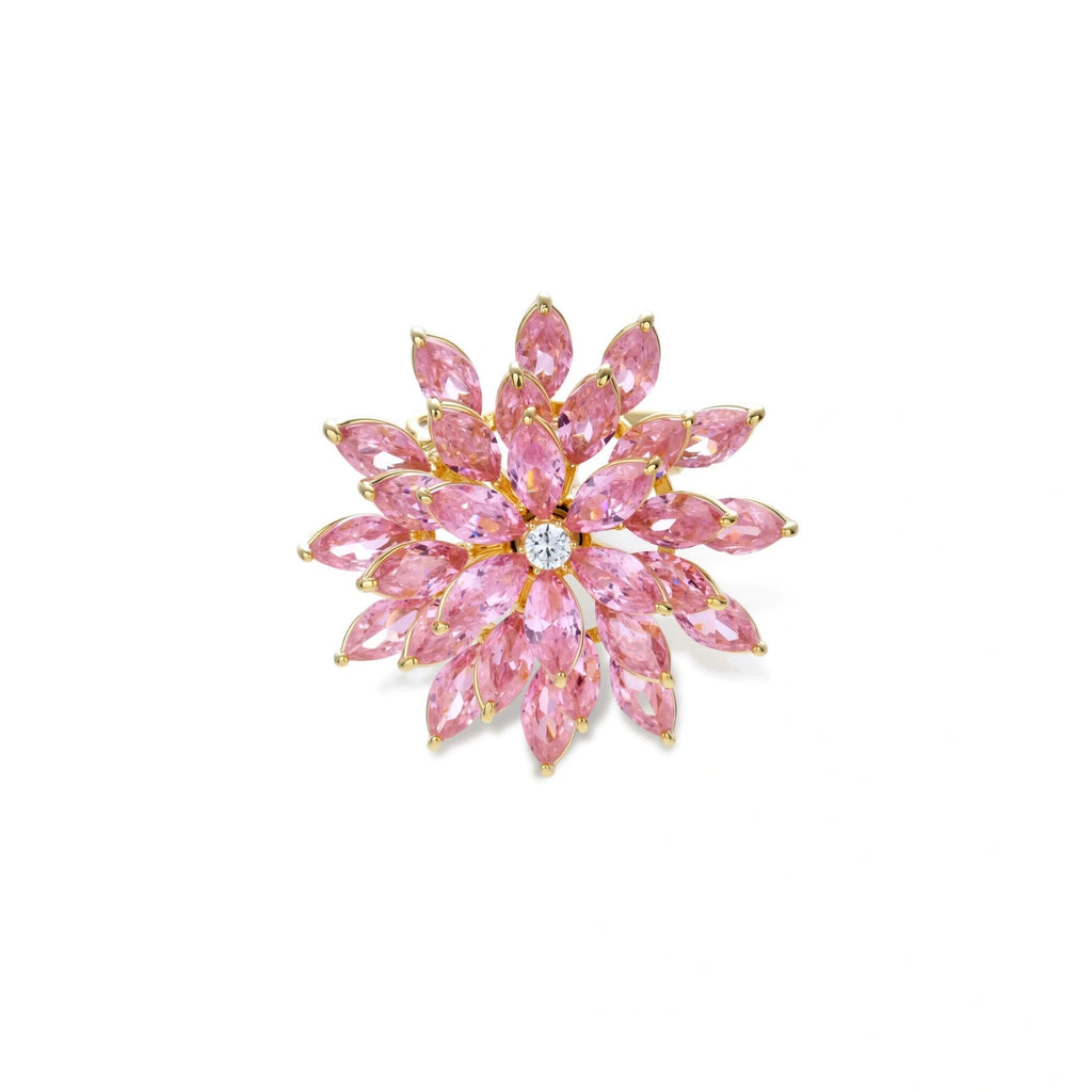 Pink cubic zirconia brooch in floral starburst design with palladium-plated copper setting on white background.