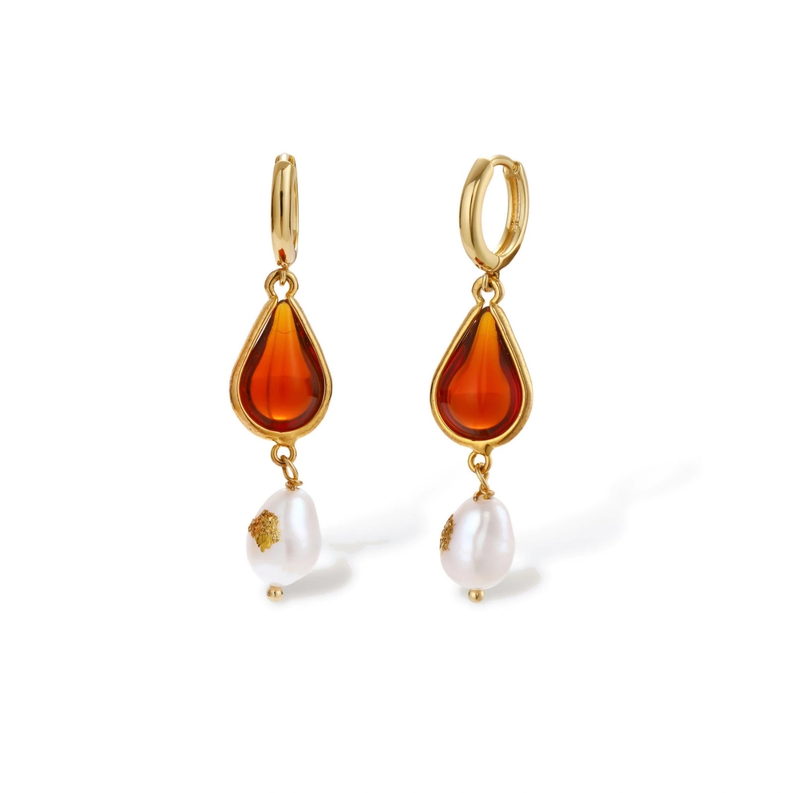 Gold-plated drop earrings featuring amber teardrops and white baroque pearls on light background.