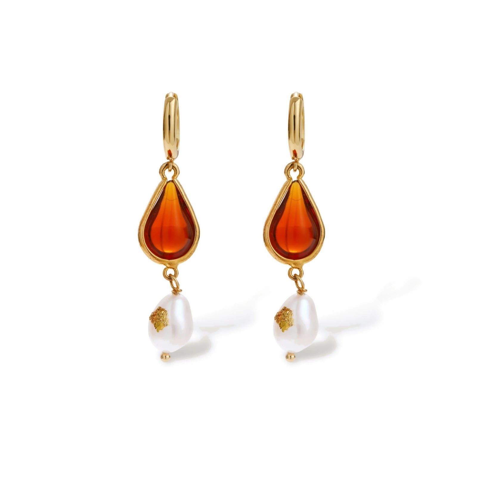 Gold-plated drop earrings featuring amber teardrops and white baroque pearls on light background.