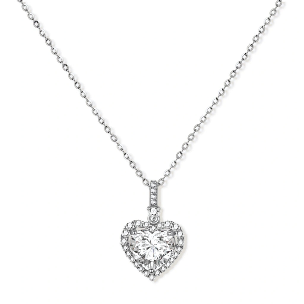 Complete jewelry set with heart-shaped sterling silver pieces featuring brilliant moissanite stones on white background.