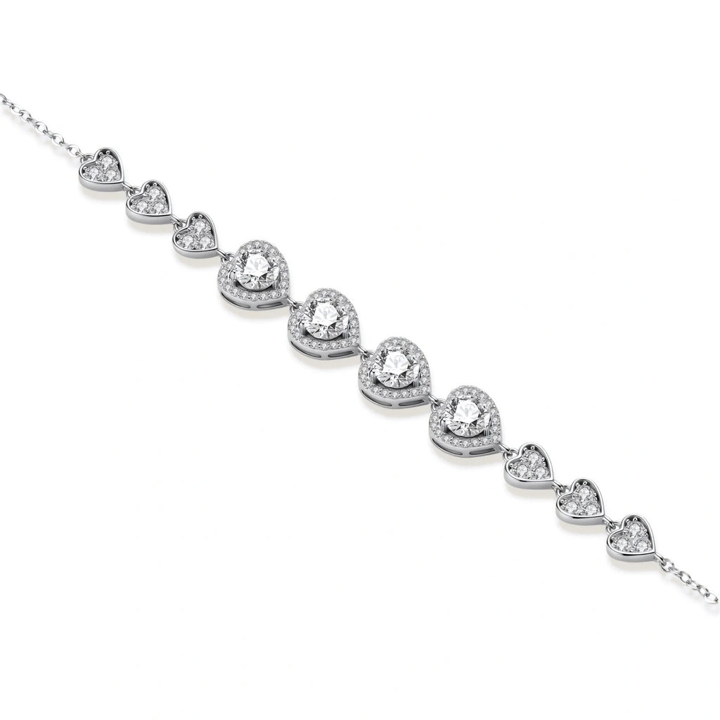 Complete jewelry set with heart-shaped sterling silver pieces featuring brilliant moissanite stones on white background.