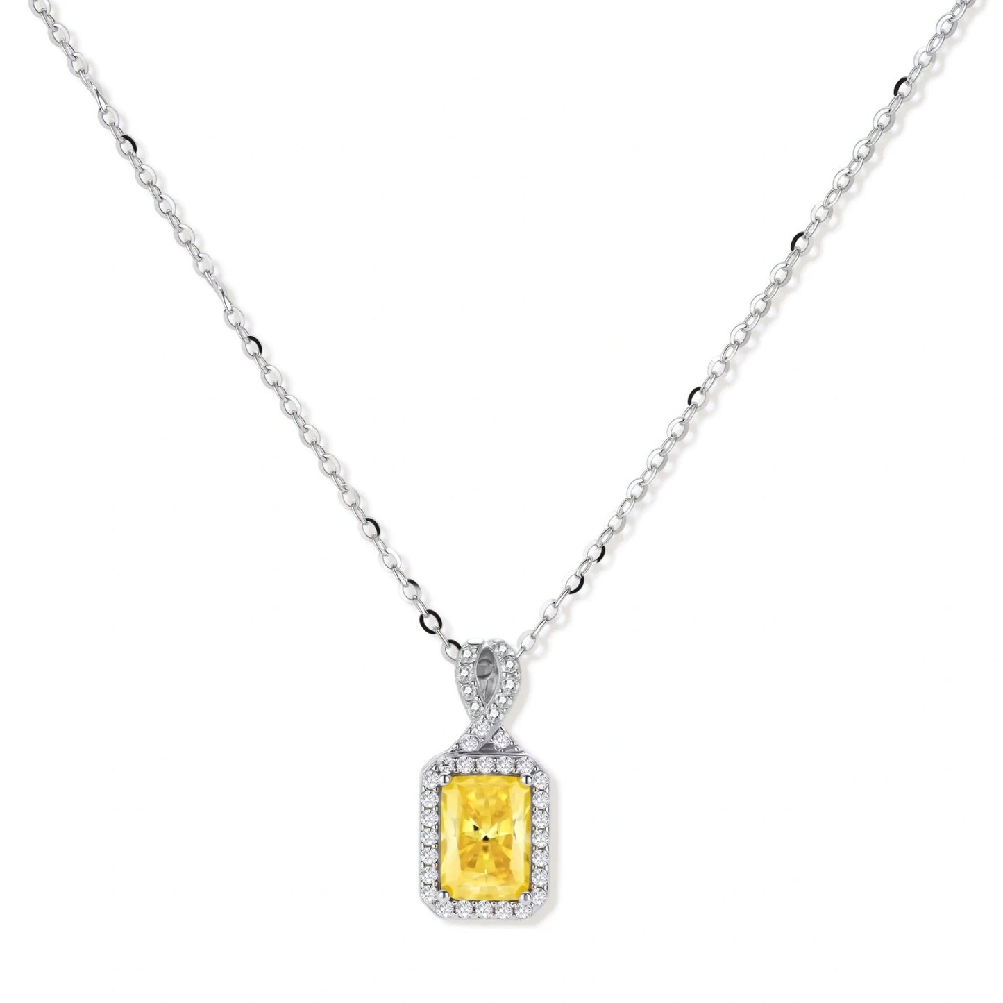 Yellow moissanite jewelry set with emerald-cut stones in sterling silver halo settings on white background.