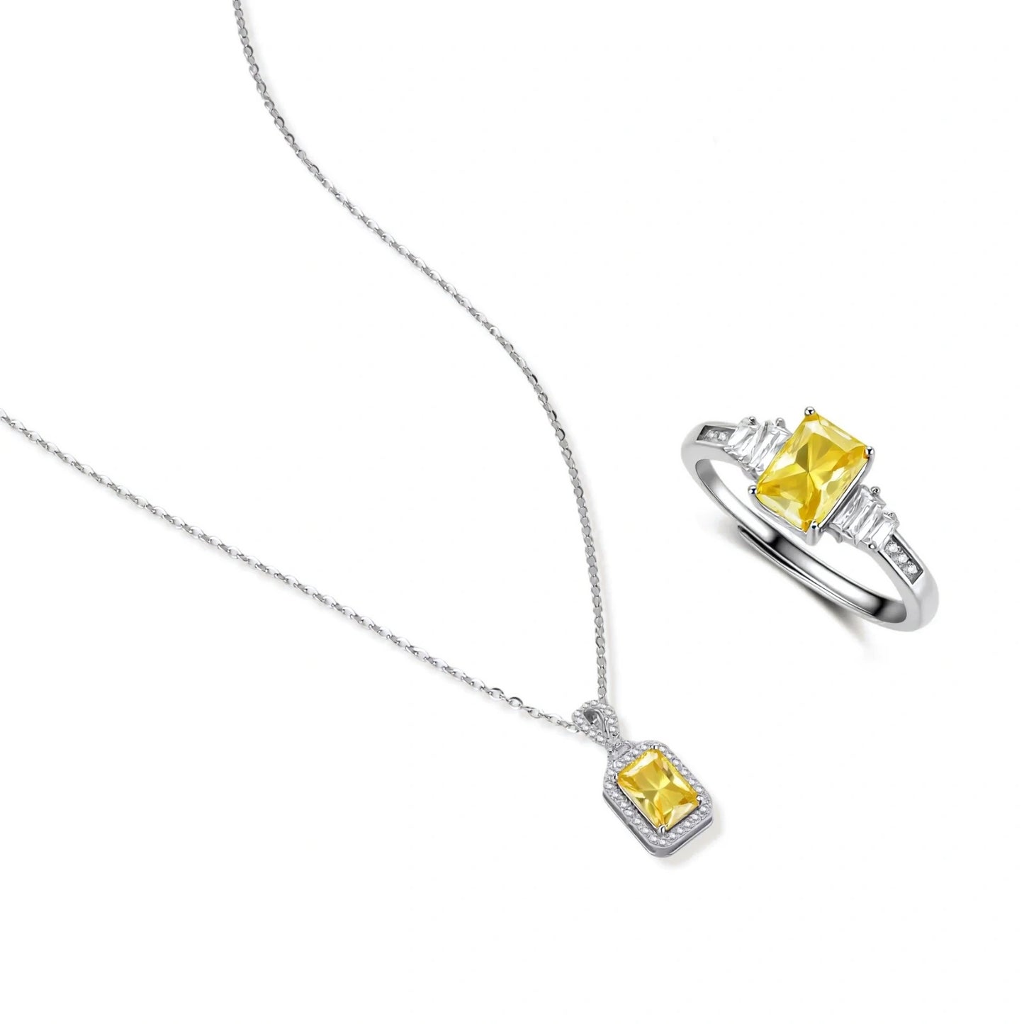 Yellow moissanite jewelry set with emerald-cut stones in sterling silver halo settings on white background.
