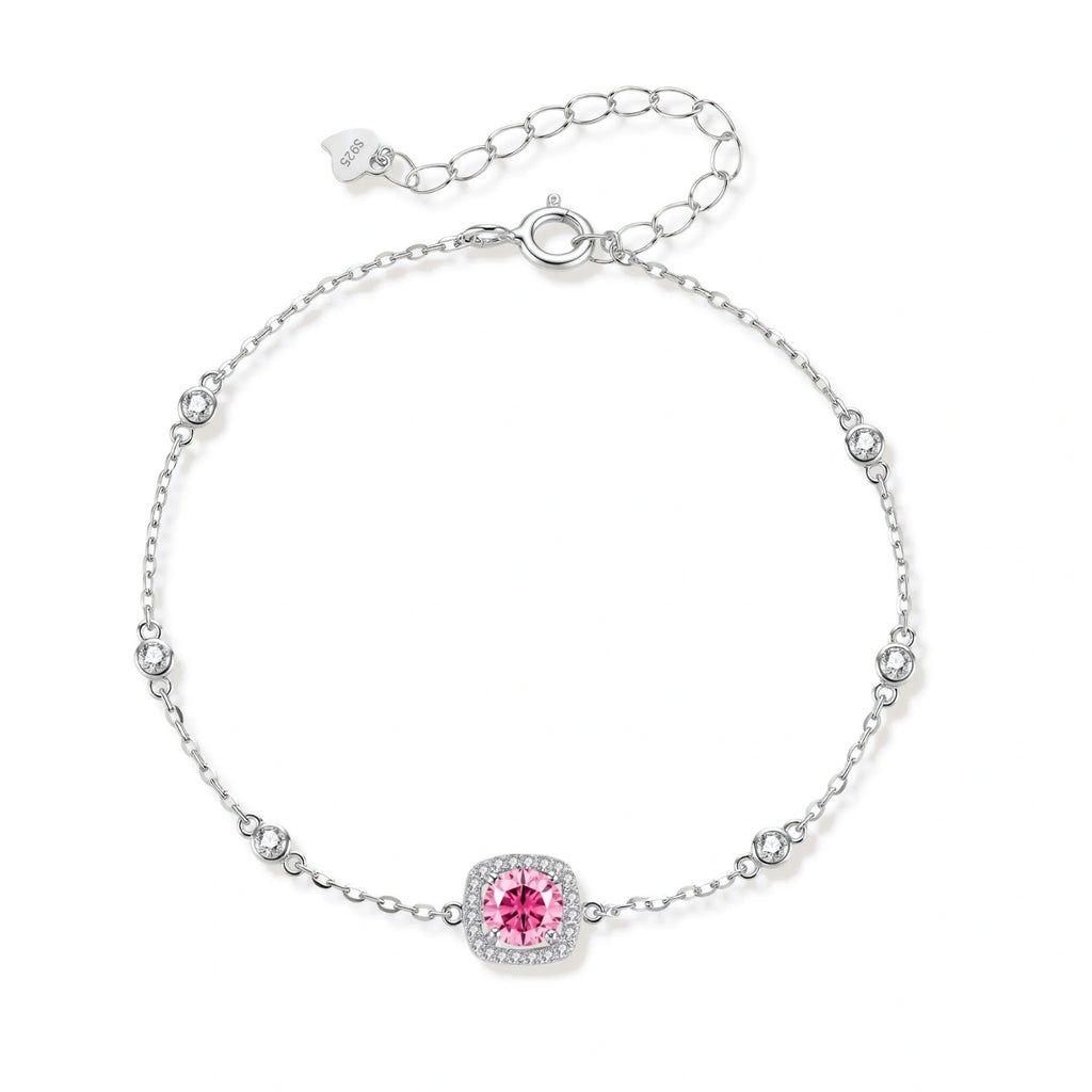Sterling silver jewelry set featuring pink moissanite stones in halo settings on white background.