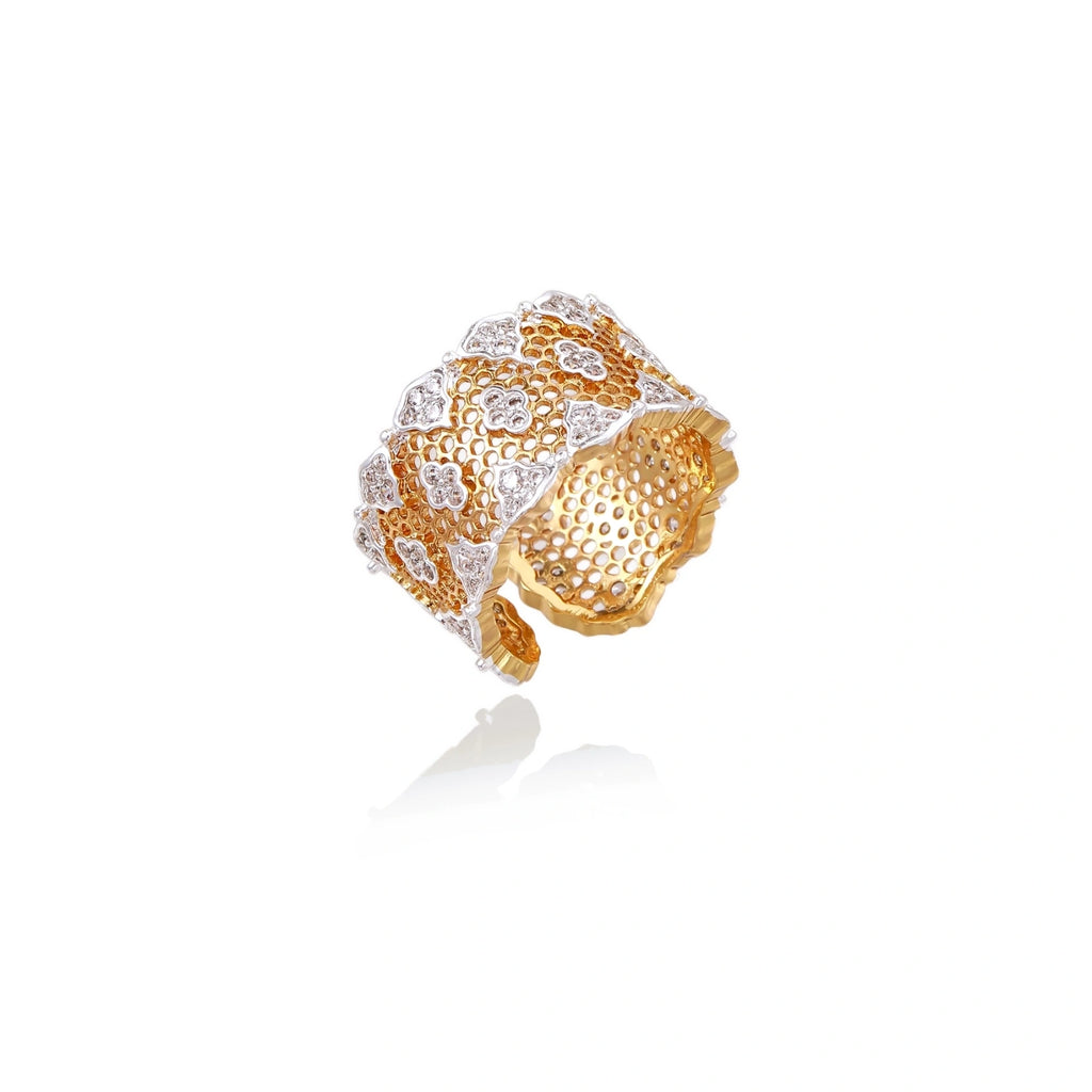 Two-tone gold and silver lattice ring with clover pattern and crystal accents on white background
