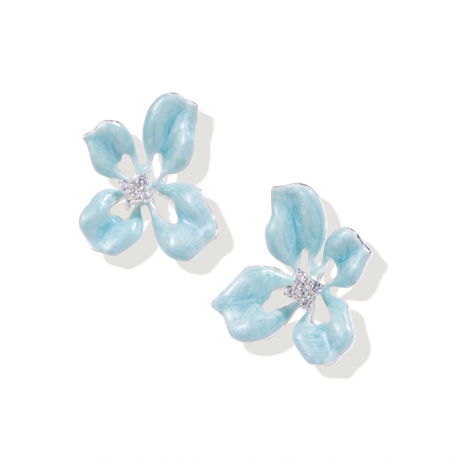 Turquoise enamel flower stud earrings with marbled finish and crystal centers on 18K gold plated brass