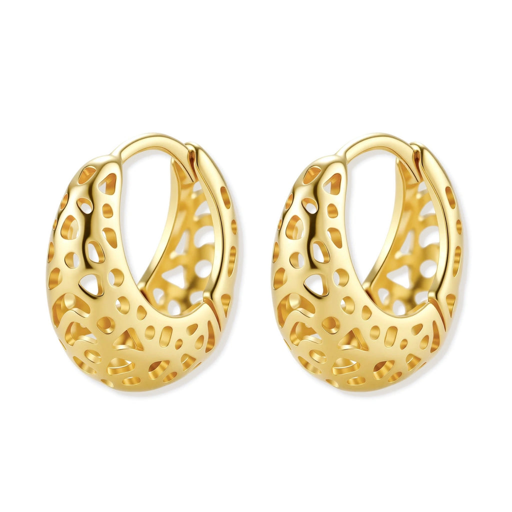 Close-up of small gold-plated hoop earrings with intricate honeycomb cutout pattern on cream background.