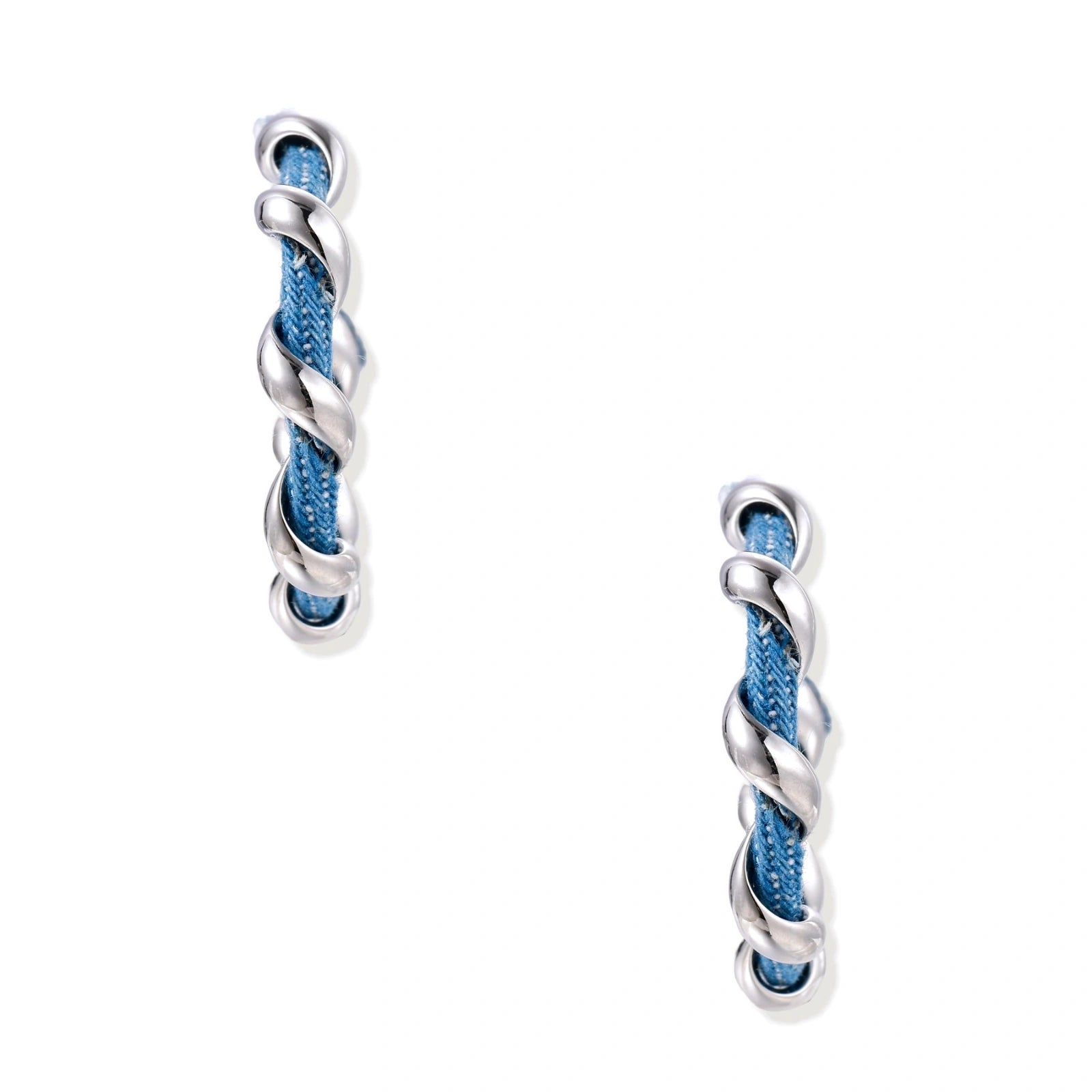 White gold-plated hoops intertwined with blue denim fabric in a twisted rope design on cream background.