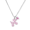 Pink enamel teddy bear pendant with crystal accents and heart charm on white gold chain