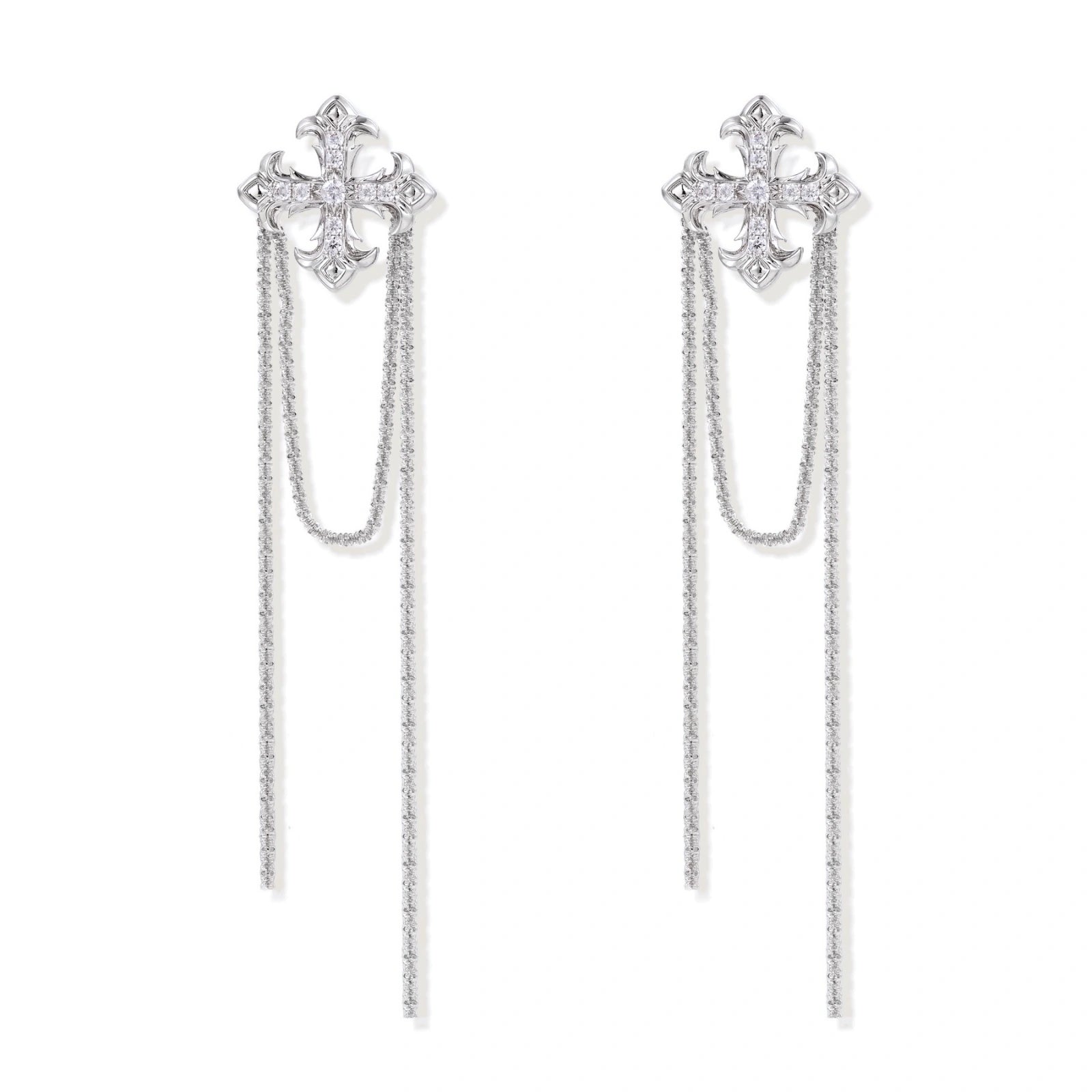 White gold plated baroque cross stud earrings with long cascading zirconia chains on cream background