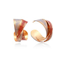 Sculptural gold-plated hoop earrings with diagonal purple and coral enamel stripes in twisted ribbon design