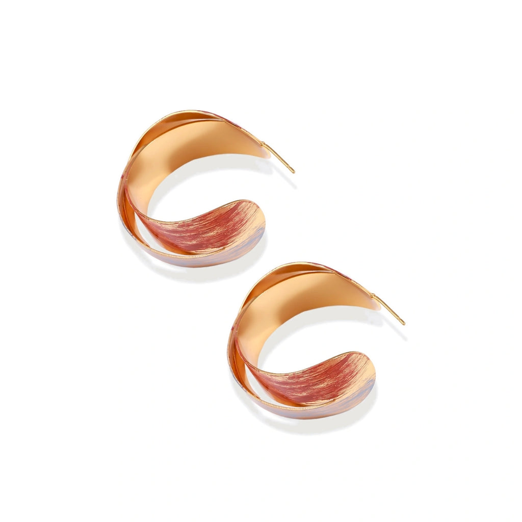 Sculptural gold-plated hoop earrings with diagonal purple and coral enamel stripes in twisted ribbon design