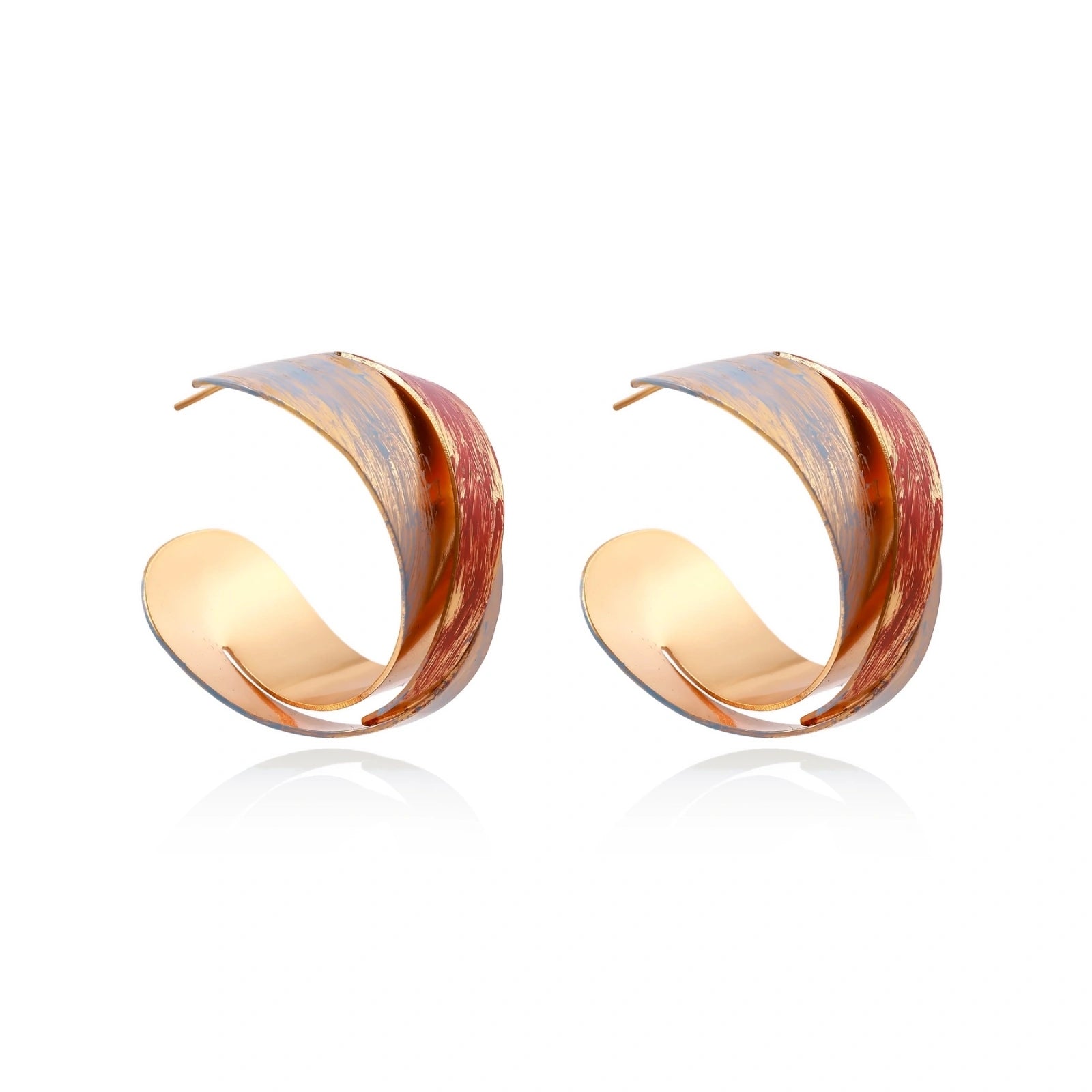 Sculptural gold-plated hoop earrings with diagonal purple and coral enamel stripes in twisted ribbon design