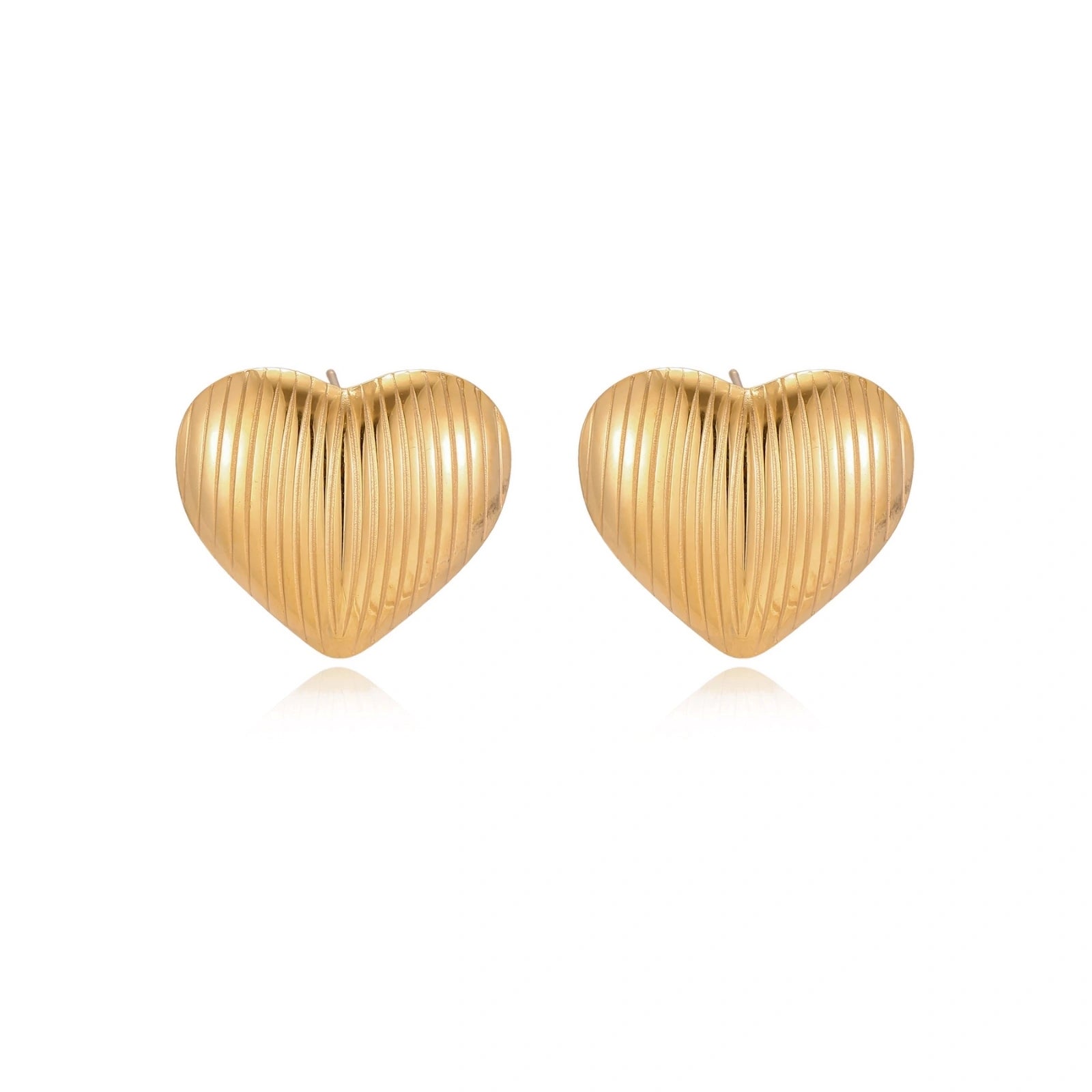 Gold heart-shaped stud earrings with parallel ridged texture on cream background