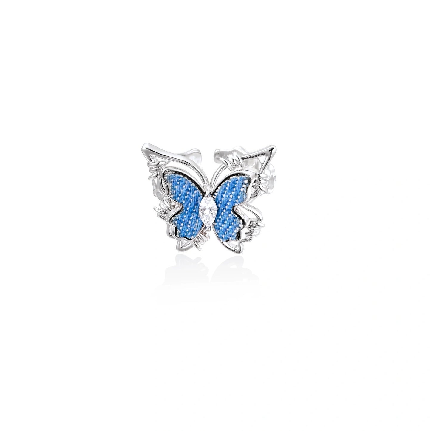 Silver-toned ring with blue denim butterfly wings, marquise zirconia center, and ornate scrollwork band on white background