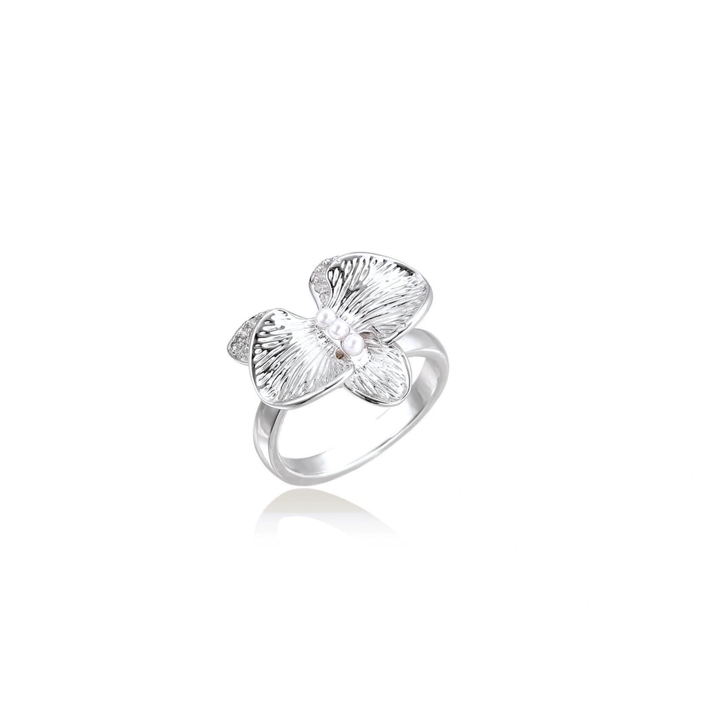 Silver-toned orchid ring with textured petals, pearl center accents, and sparkling zirconia stones on white background.