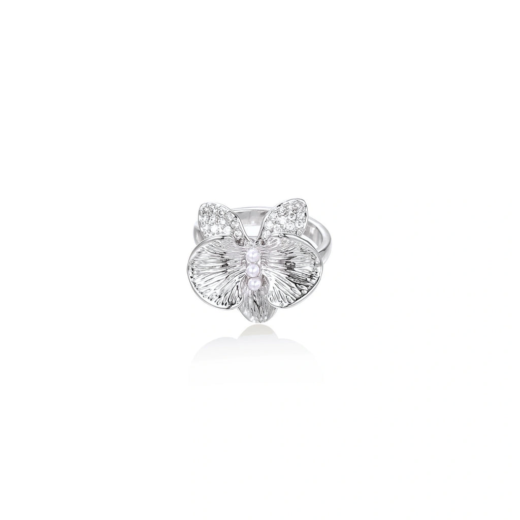 Silver-toned orchid ring with textured petals, pearl center accents, and sparkling zirconia stones on white background.