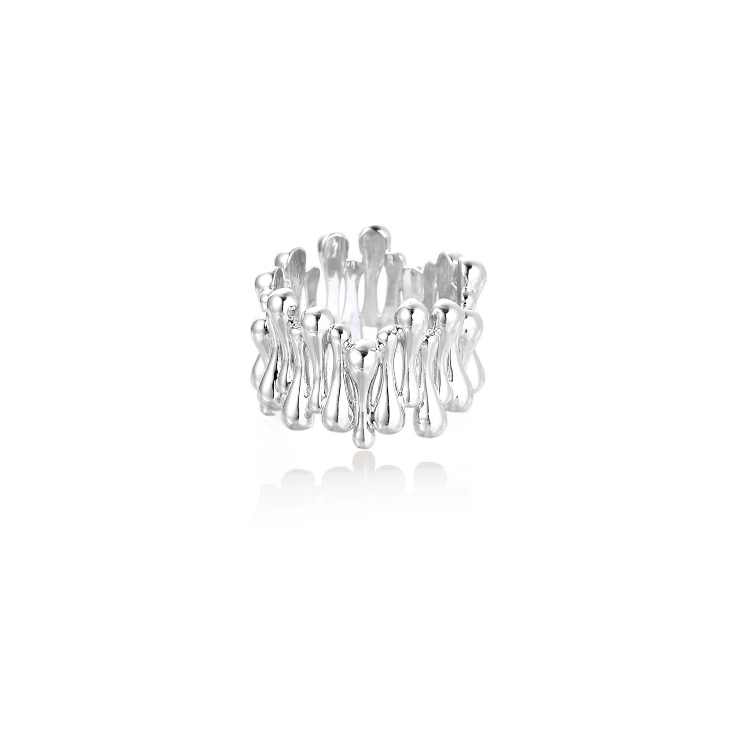 Wide band ring with sculptural wave ripples in polished white gold plated eco-brass on cream background
