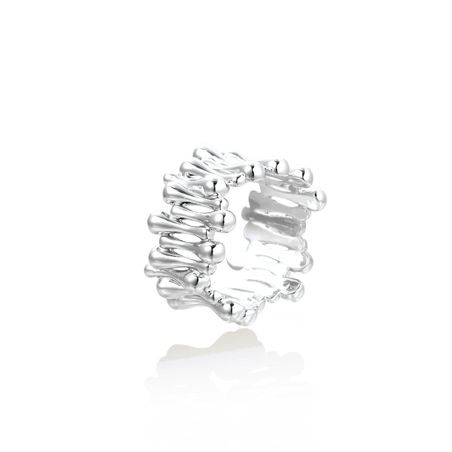 Wide band ring with sculptural wave ripples in polished white gold plated eco-brass on cream background