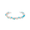Delicate wire-wrapped bracelet featuring turquoise, rose quartz, freshwater pearls, and zircon on a white background.