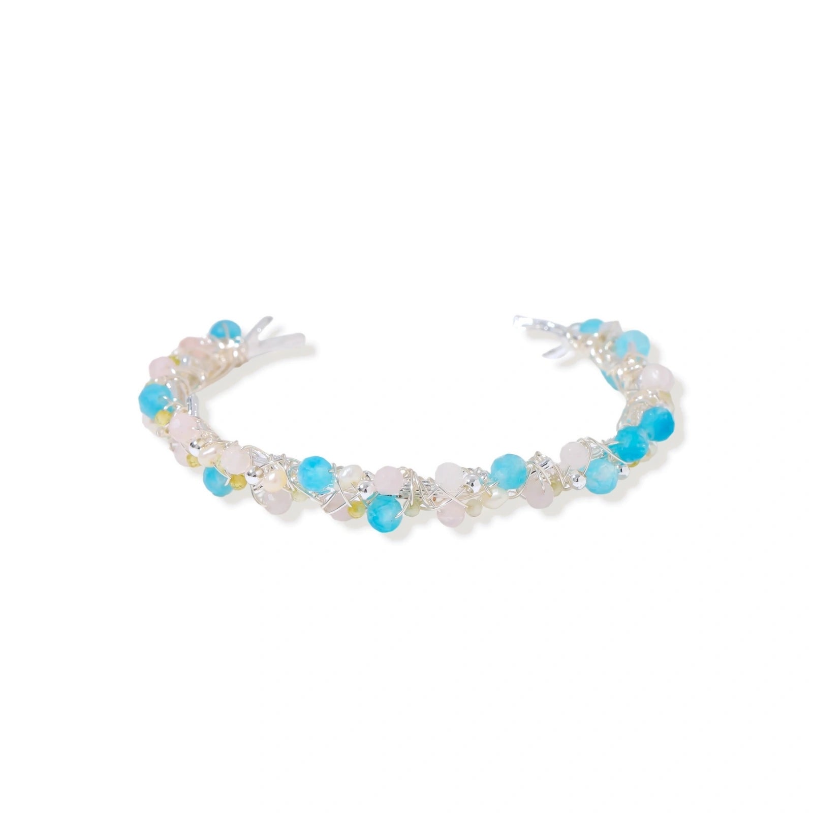 Delicate wire-wrapped bracelet featuring turquoise, rose quartz, freshwater pearls, and zircon on a white background.