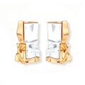Close-up of avant-garde sculptural earrings with flowing liquid metal design in gold and silver tones on white background.