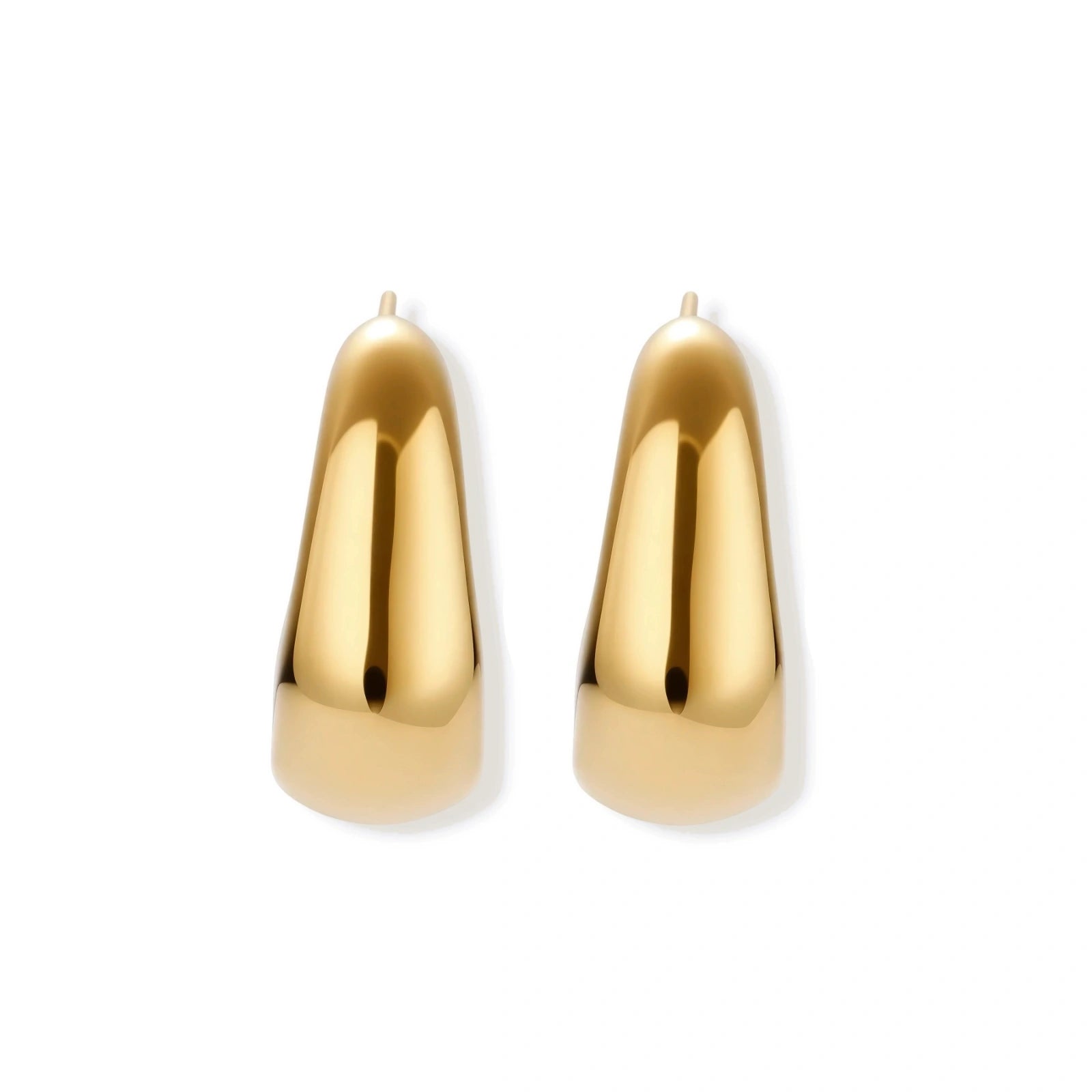 Close-up of curved gold-plated huggie earrings with sculptural design on white background, showing polished finish.