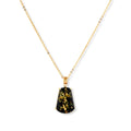 18k gold-plated necklace and earrings with green amber pendants featuring golden inclusions on cream background