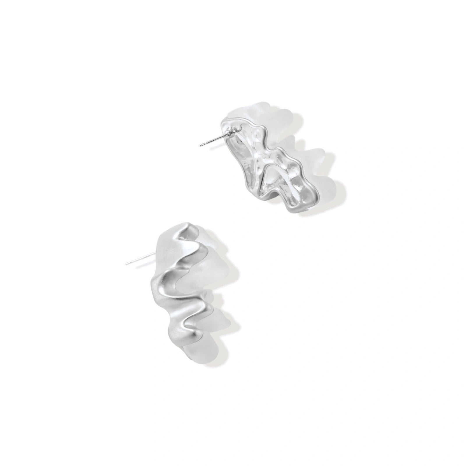 Pair of silver-toned sculptural earrings with flowing abstract forms and stud backs against white background.