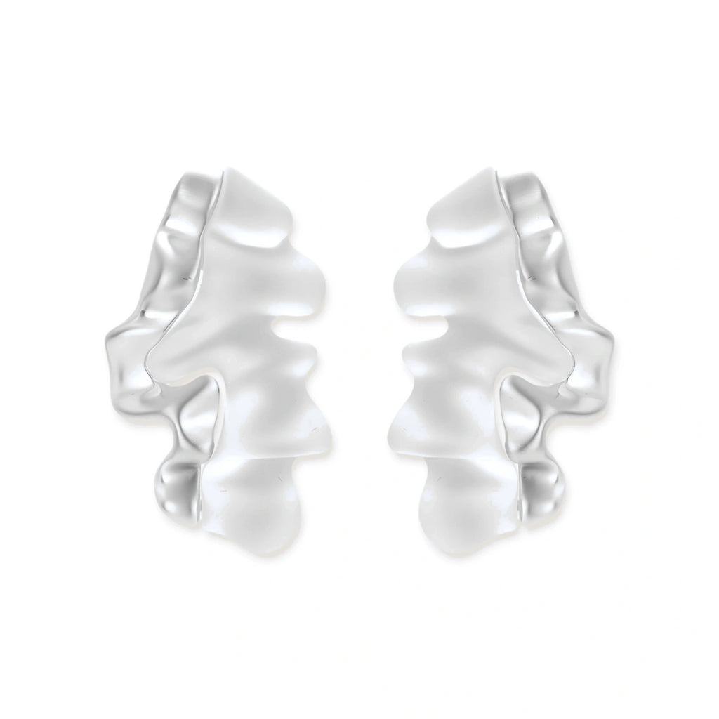 Pair of silver-toned sculptural earrings with flowing abstract forms and stud backs against white background.
