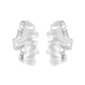Pair of silver-toned sculptural earrings with flowing abstract forms and stud backs against white background.