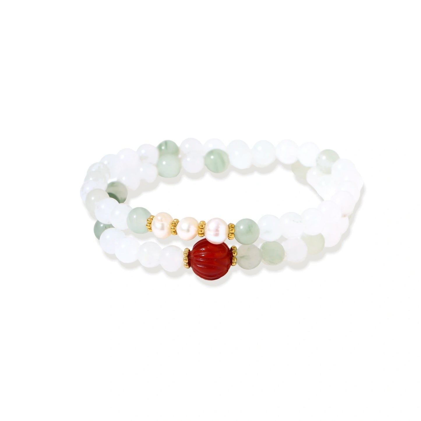 Three layered white beaded bracelets with carved orange agate lotus centerpiece and freshwater pearls on cream background.