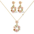 14K gold plated jewelry set with pink and green cubic zirconia flowers arranged in wreath design on cream background