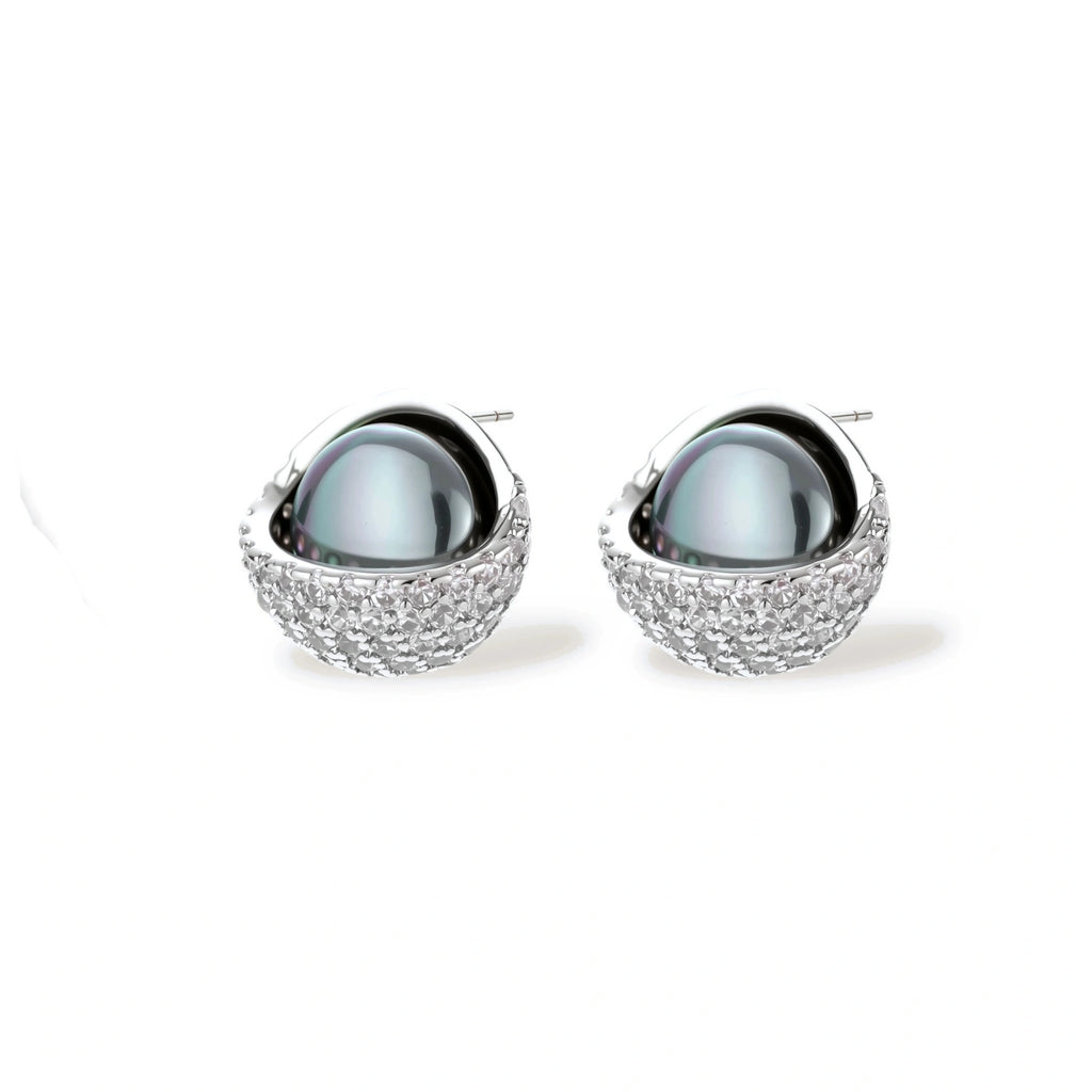 White gold plated spherical jewelry set with zirconia crystal pavé and dark lustrous centers on neutral background.