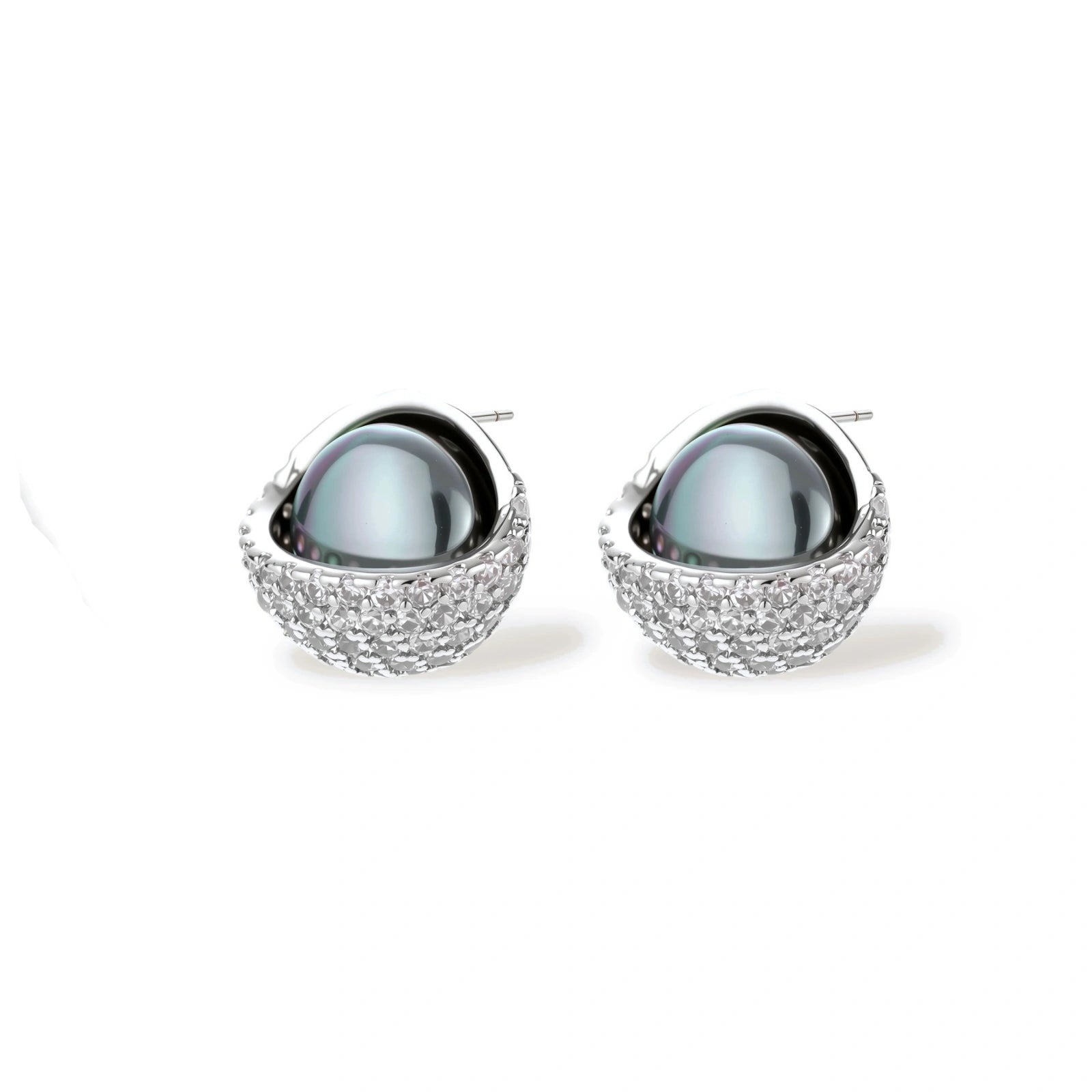 White gold plated spherical jewelry set with zirconia crystal pavé and dark lustrous centers on neutral background.