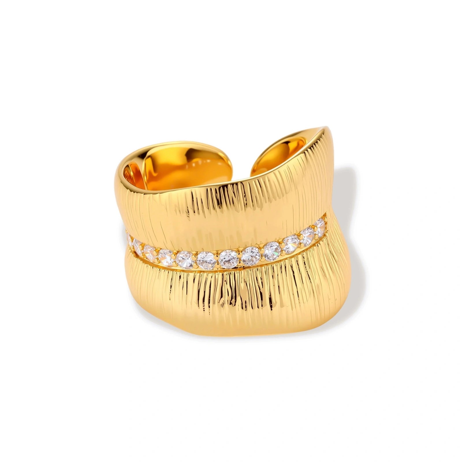 Adjustable gold-plated cuff ring with parallel ridged texture and diagonal row of sparkling zirconia stones on white background.