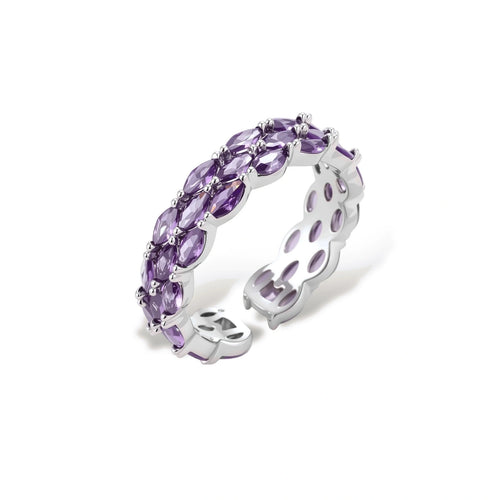 Close-up of adjustable ring with oval purple zirconia stones in white gold-plated copper setting on neutral background.