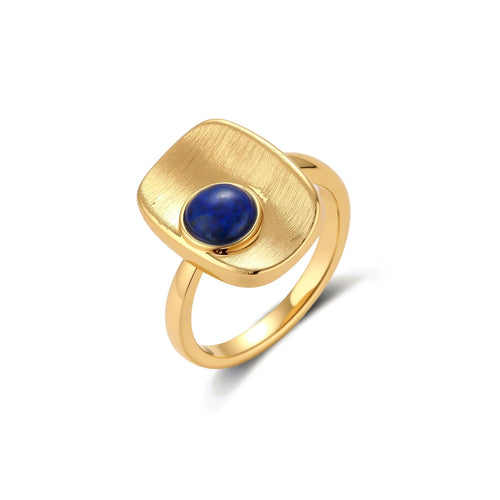 Adjustable gold-plated ring with textured square setting featuring a round blue lapis lazuli stone on cream background.