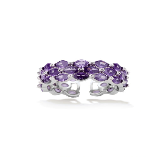 Close-up of adjustable ring with oval purple zirconia stones in white gold-plated copper setting on neutral background.