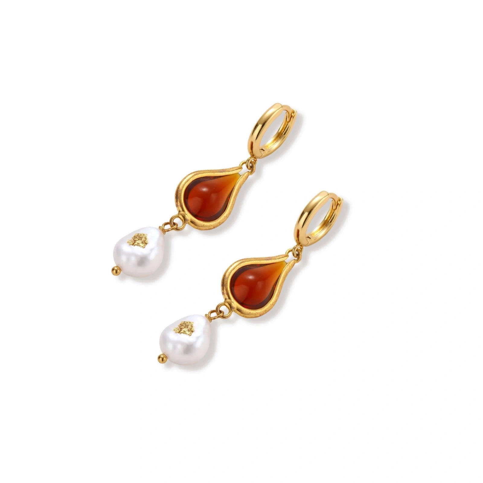 Gold-plated drop earrings featuring amber teardrops and white baroque pearls on light background.