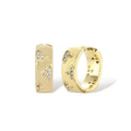 Gold-plated hoop earrings with textured surface and raised floral motifs set with clear zirconia stones on cream background.